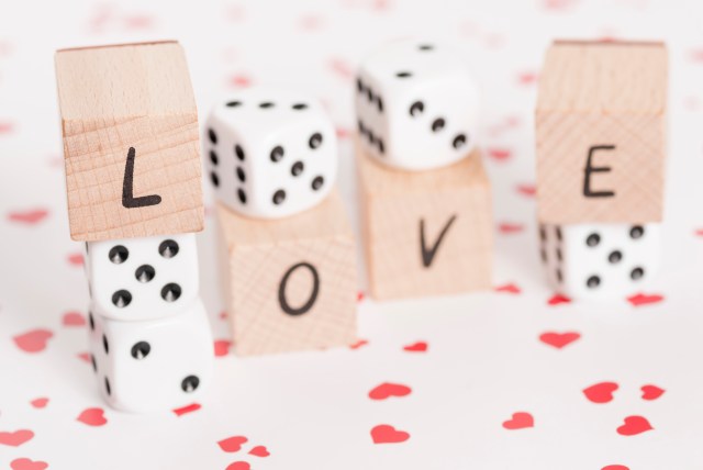 Love and Dice on Heart Background.